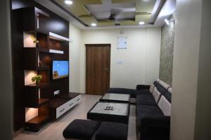 a living room with a couch and a tv at Shivalay - By Safarnama Stays in Varanasi