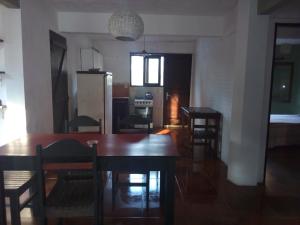 a kitchen and dining room with a table and chairs at PORTOFINO Piriapolis in Piriápolis