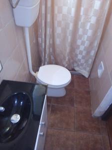 a small bathroom with a toilet and a sink at PORTOFINO Piriapolis in Piriápolis