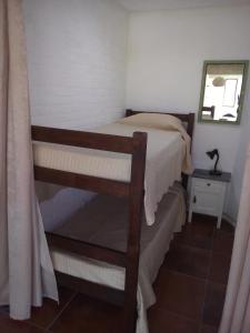a small bedroom with a bunk bed and a mirror at PORTOFINO Piriapolis in Piriápolis