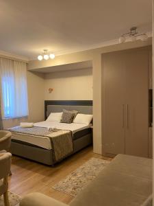 a bedroom with a bed and a sliding door at Al Posto Giusto apartments in Igalo