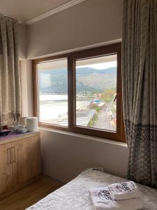 a bedroom with a window with a view of a beach at Al Posto Giusto apartments in Igalo