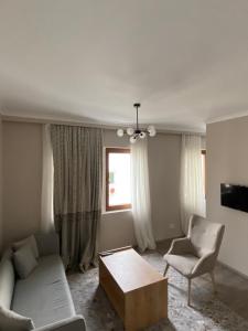 a living room with a couch and a chair at Al Posto Giusto apartments in Igalo +14 photos