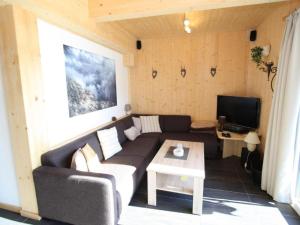 a living room with a couch and a tv at Wolkenheim in Hohentauern