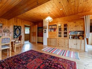 a living room with a wooden ceiling and a dining room at Landhaus zur Sonne in Diex