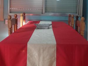 a table with a red and white table cloth at RINCÓN Del DESCANSO in Oberá +6 photos