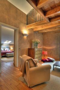 a living room with a couch and a bedroom at Hotel Cristallo in Alagna Valsesia