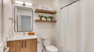 a bathroom with a toilet and a sink and a mirror at 1115 Aerie Buyout 2 Units Near Downtown Hot Tub Mountain View in Bend +45 photos