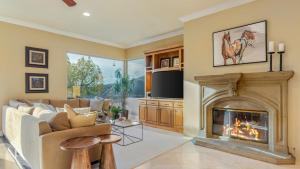 a living room with a couch and a fireplace at Cleveland Vista by AvantStay Pool Hot Tub Fire Pit Panoramic Views in Murrieta