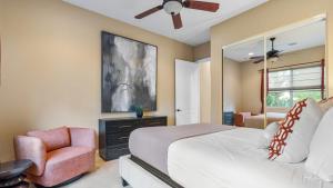 a bedroom with a bed and a chair and a window at Cleveland Vista by AvantStay Pool Hot Tub Fire Pit Panoramic Views in Murrieta +65 photos