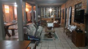 a living room with a couch and a table at Casa Dona Hilda Blumenau in Blumenau