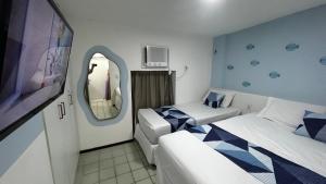 Giường trong phòng chung tại Ancorar Flat Resort a Beira Mar 2 Quartos em Porto de Galinhas +44 ảnh