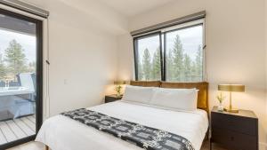 a bedroom with a bed and large windows at 2 Units Minutes to Old Bend Deck Hot Tub 1216 Skyline Ranch by AvantStay in Bend