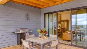 a patio with a table and chairs and a kitchen at 2 Units Minutes to Downtown Bend Hot Tub 1208 Skyline Ranch by AvantStay in Bend