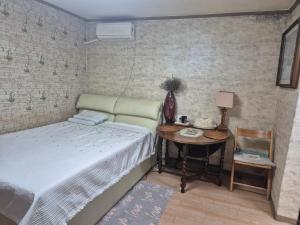 a bedroom with a bed and a table with a telephone at Ara house싱글 in Seoul +5 photos
