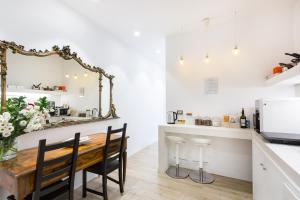 a kitchen with a wooden table and a mirror at Deluxe Ripetta 41 in Rome