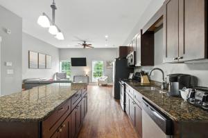 a kitchen with marble counter tops and a living room at New Listing Bulldog Borough in Downtown Athens in Athens