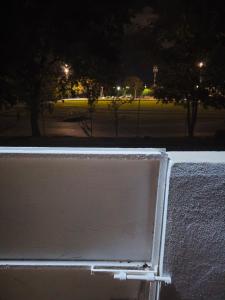 a white wall with a park in the background at night at Diversity in San Juan +5 photos