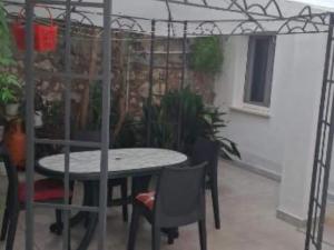 a patio with a table and chairs in a room at Studio Apartment Sineva in Šibenik