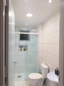 a bathroom with a shower and a toilet and a sink at Porto dos Açores in Laguna