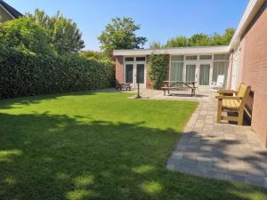 a backyard with a picnic table and a building at with large, fenced garden DL108 in Domburg
