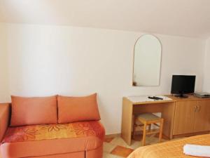 a bedroom with a bed and a desk with a mirror at Apartments Pansion Franka 3 - Apartment 1B in Brist