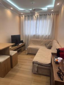 a bedroom with two beds and a television in it at Linkin Home Mapp Rio Branco in Sao Paulo