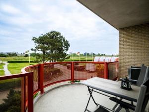 a patio with a table and chairs on a balcony at Holiday apartment in Buren with swimming pool in Buren
