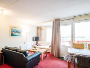 a living room with a couch and a table at Holiday apartment in Buren with swimming pool in Buren