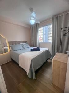 a bedroom with a bed and a large window at Linkin Home Mapp Rio Branco in Sao Paulo