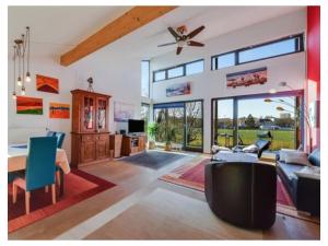 a living room with a ceiling fan and a table at Holiday apartment in Munich with Wi-Fi in Munich