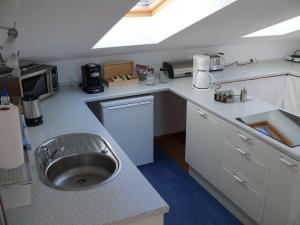 a kitchen with a sink and a counter top at Holiday apartment in Munich with Wi-Fi in Munich +18 photos