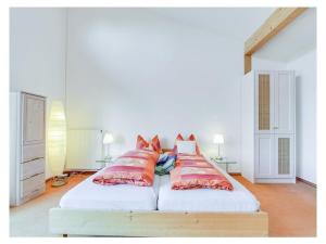 a bedroom with a large bed with red pillows at Holiday apartment in Munich with Wi-Fi in Munich