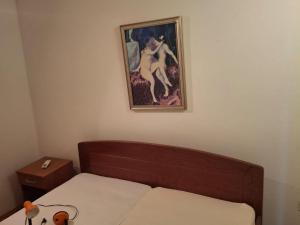 a bedroom with a bed and a painting on the wall at Villa Jagoda - Three Bedroom Villa in Gornji Dingač