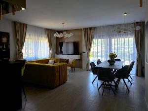 a living room with a yellow couch and a table at Villa Golden Grain - Four Bedroom Villa in Čibača