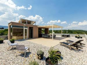 a house on a hill with a patio at Luxury Villa Lara with Heated Pool, Hot-Tub and Sauna - Six Bedroom Villa with Pool in Zmijavci