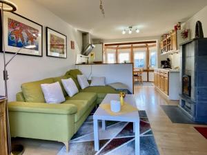 a living room with a green couch and a table at Holiday home with 2 bedrooms in Schwollen