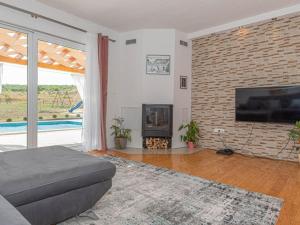 a living room with a fireplace and a brick wall at Villa Maria with Outdoor Pool - Five Bedroom Villa with Outdoor Pool in Otavice