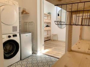 a laundry room with a washing machine and a washer at Holiday Home in Petten near the Beach in Sint Maartensvlotbrug