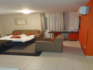 a living room with a bed and a couch at Marina Portoro Family Friendly Apartment 4 - Two Bedroom Apartment in Lucija