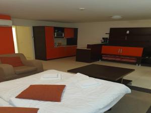a living room with a white bed and a kitchen at Marina Portoro Family Friendly Apartment 4 - Two Bedroom Apartment in Lucija