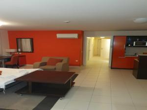 a living room with red walls and a couch and a table at Marina Portoro Family Friendly Apartment 4 - Two Bedroom Apartment in Lucija +10 photos