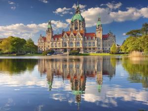 a large building with its reflection in the water at Holiday apartment in Hanover with barbecue in Hannover