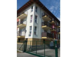 an apartment building with balconies and a fence at One-bedroom apartment in Czajczyn