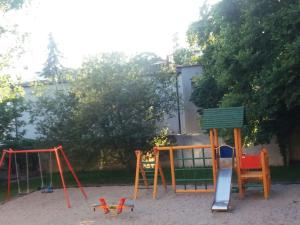 a playground with colorful chairs and a swing at One-bedroom apartment in Czajczyn