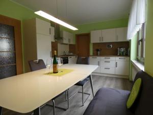 a kitchen with a table with two wine glasses on it at Holiday home with 3 bedrooms in Treis-Karden +34 photos