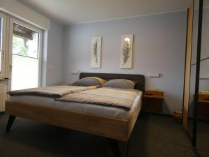 a bedroom with a large bed with two pictures on the wall at Holiday home with 3 bedrooms in Treis-Karden