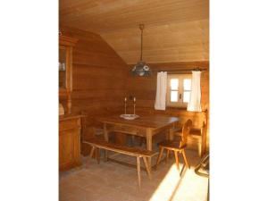a dining room with a wooden table and chairs at 1-bedroom holiday home in Sachrang