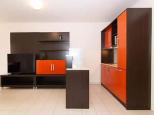 a large kitchen with orange and black cabinets at Marina Portoro Family Friendly Apartment 3 - Two Bedroom Apartment in Lucija