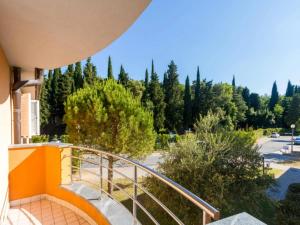 a balcony with a view of a street and trees at Marina Portoro Family Friendly Apartment 3 - Two Bedroom Apartment in Lucija